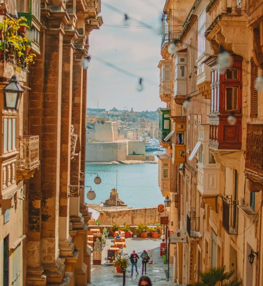 Narrow street in Valletta with traditional wooden balconies